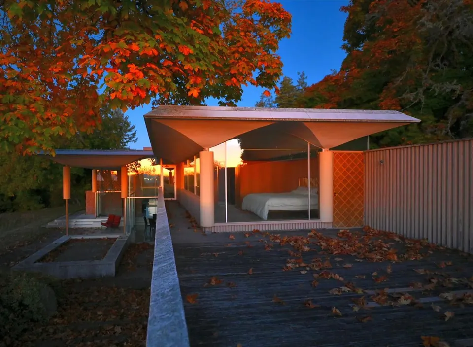 Front approach to the Filberg House beneath red autumn leaves.