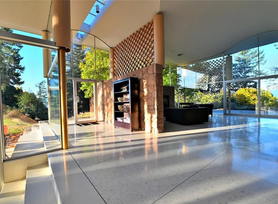 Filberg House living area with granite hearth, copper hood and glazed walls.