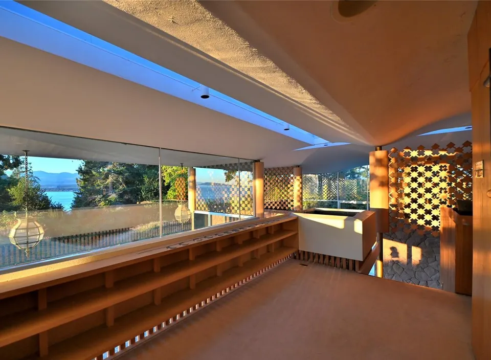 Filberg House living room with skylight, cedar screens and broad glazing.